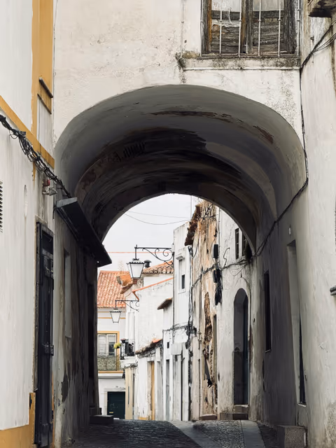 arched passage leading to a narrow cobblestone street