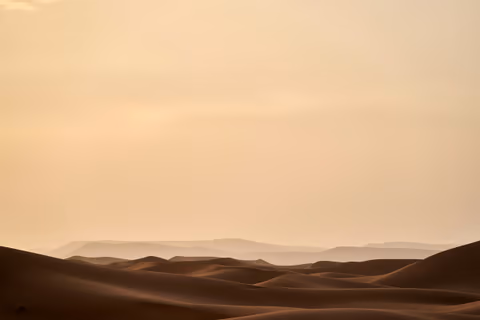 a person riding a horse in the desert