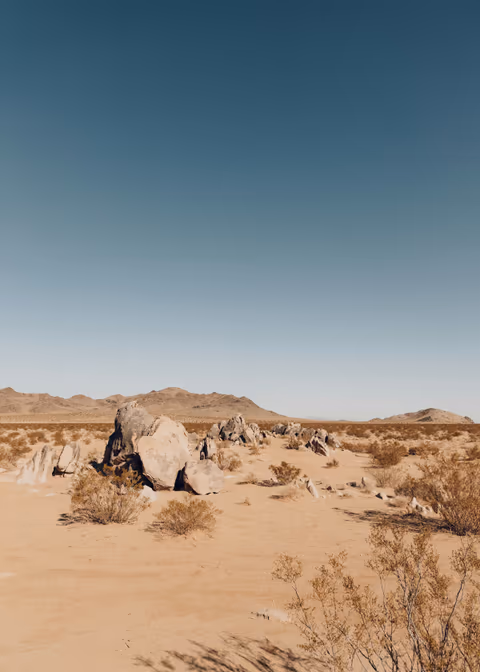 brown sand under blue sky
