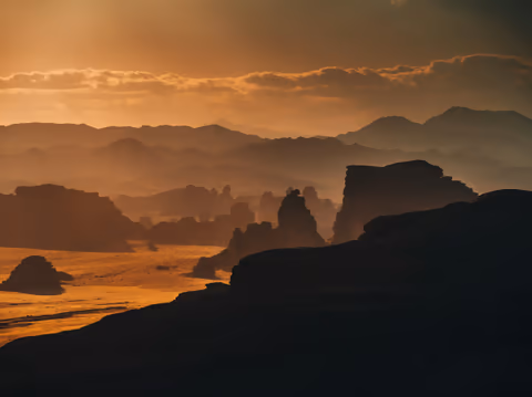 the sun setting over a mountain range
