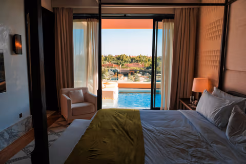 bedroom opening onto a terrace and pool
