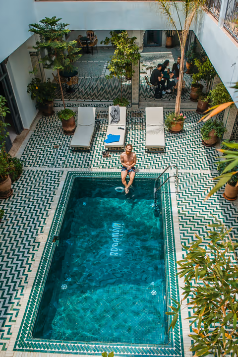 guest sitting at the edge of the pool