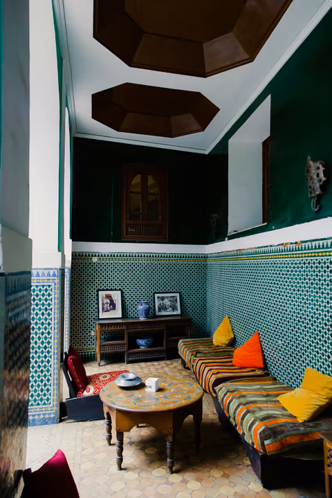 green-tiled lounge with a wooden table