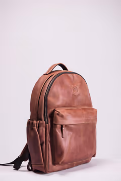 tan leather backpack, three-quarter view