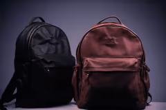 the backpack in black and tan side by side