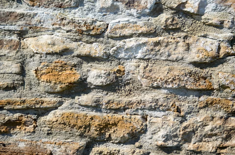 a close up of a brick wall with small holes