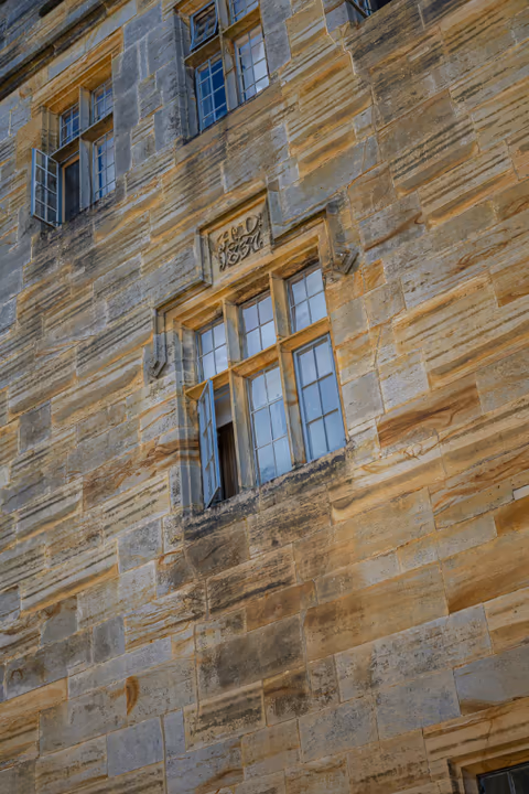 old stone building facade with multiple windows
