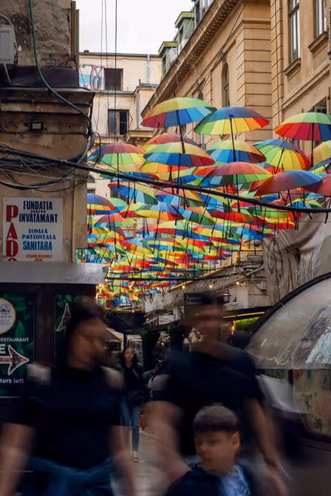 people walking under umbrellas