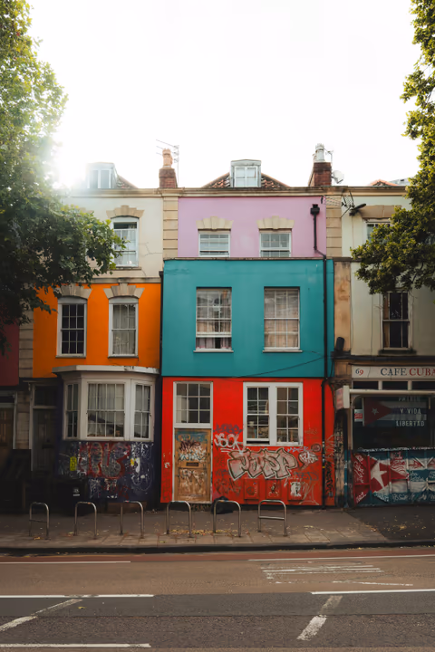 colorful houses with graffiti on a city street